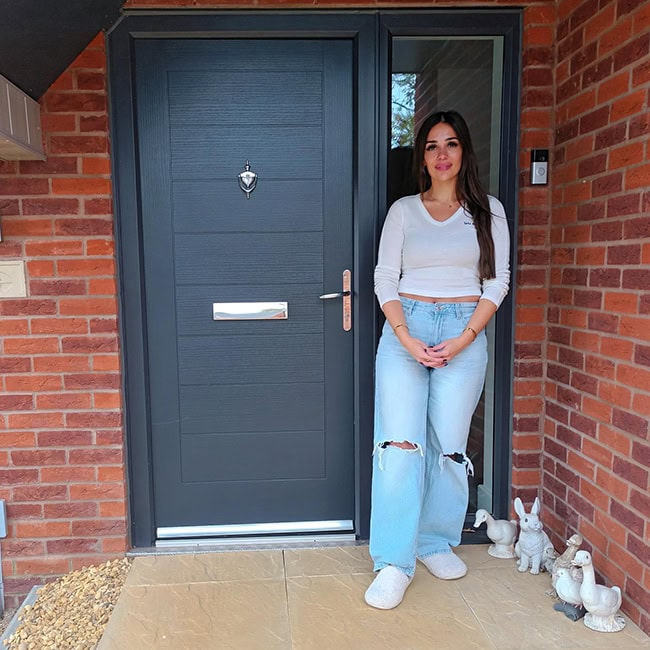 Aysha Plot 8 Modern front door at Brampton Valley Homes with a welcoming resident standing outside, showcasing stylish and secure house entryways for your ideal home.